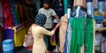 a female customer searching for best dress at street shop in india