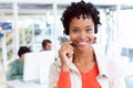 Female customer service executive with headset looking at camera in office Royalty Free Stock Photo