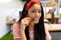 Female customer service executive looking at camera while talking on headset in a modern office Royalty Free Stock Photo