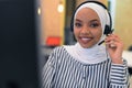 Female Customer Service Representative Answer Client`s Questions in a Headset. Multi-Ethnic Team of Specialists. Happy african Royalty Free Stock Photo