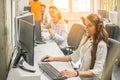 Female customer services agent with Headset working in a call center. Royalty Free Stock Photo