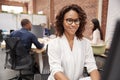 Female Customer Services Agent Working At Desk In Call Center Royalty Free Stock Photo