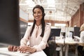 Female Customer Services Agent Working At Desk In Call Center Royalty Free Stock Photo