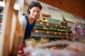 Female Customer With Shopping Basket Buying Fresh Apples In Organic Farm Shop