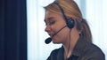 Female customer support operator with headset talking and smiling Royalty Free Stock Photo