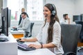 Female customer support phone operator at modern office. Royalty Free Stock Photo