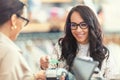 Female customer using card payment to pay in the garment boutique to the shop assistant Royalty Free Stock Photo