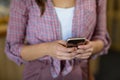 Female customer using mobile phone in grocery shop Royalty Free Stock Photo