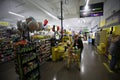 Female customer using self-checkout at Dollar General with her daughter in the cart