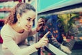 Female customer watching fish in aquarium tank Royalty Free Stock Photo