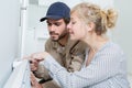 Female customer watching male plumber work Royalty Free Stock Photo