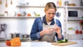 Female cut finger while slicing cucumber, accident in kitchen, household injury Royalty Free Stock Photo