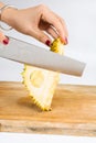 Female cutting durian fruit on wooden board