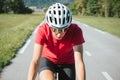 Female cycling rider in maximal effort during an uphill race