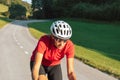 Female cycling rider in maximal effort during an uphill race