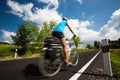 Female cyclist biking on a country road Royalty Free Stock Photo