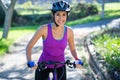 Female cyclist cycling in countryside on sunny day