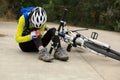 Female cyclist getting injured while falling from mountain bike Royalty Free Stock Photo