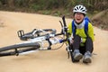 Female cyclist getting injured while falling from mountain bike Royalty Free Stock Photo