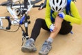 Female cyclist getting injured Royalty Free Stock Photo