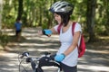female cyclist looking at smartwatch Royalty Free Stock Photo