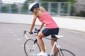 Female cyclist making excercise on race bike. image with panning