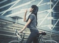 Female cyclist relaxing drinking water on a bicycle Royalty Free Stock Photo