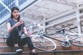 Female cyclist relaxing drinking water on a stair Royalty Free Stock Photo