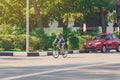 Female cyclist rides a racing bike on city road Royalty Free Stock Photo