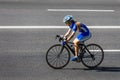 Female cyclist rides a racing bike on road Royalty Free Stock Photo