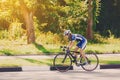 Female cyclist rides a racing bike on road Royalty Free Stock Photo