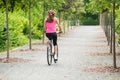 Female Cyclist Riding Away On Bicycle Royalty Free Stock Photo