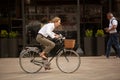 Female cyclist riding her bicycle through Piazza del Duomo