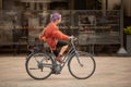 Female cyclist riding her bicycle through Piazza del Duomo