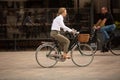 Female cyclist riding her bicycle through Piazza del Duomo