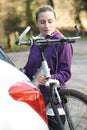 Female Cyclist Taking Mountain Bike From Rack On Car Royalty Free Stock Photo