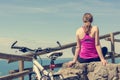 Female cyclist taking a rest and enjoying sea view. Living life. Royalty Free Stock Photo