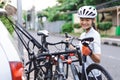 female cyclist unloading her road bicycle on a rack in the back of her car Royalty Free Stock Photo