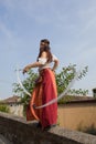 Female dancer in medieval costume dancing and swinging white ribbons