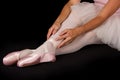 Female dancer sit on floor in pink tutu