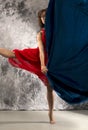 Female dancer in a turn with dark blue fabric. Royalty Free Stock Photo