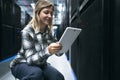 Female data center technician working inside server room Royalty Free Stock Photo