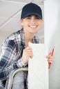 female decorator holding length decorative coving Royalty Free Stock Photo