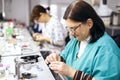 Female dental technician working on a dental prosthesis in the dental lab