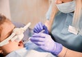 Pediatric dentist examining child teeth with dental explorer and mirror. Royalty Free Stock Photo