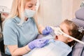 Pediatric dentist examining child teeth with dental explorer and mirror. Royalty Free Stock Photo