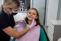 Female dentist checking and choosing teeth color with palette for girl Royalty Free Stock Photo