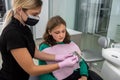 Female dentist checking and choosing teeth color with palette for girl Royalty Free Stock Photo