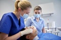 Female dentist checking patient dental occlusion