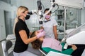 Female dentist checking up patient teeth using microscope  and instruments at modern clinic Royalty Free Stock Photo